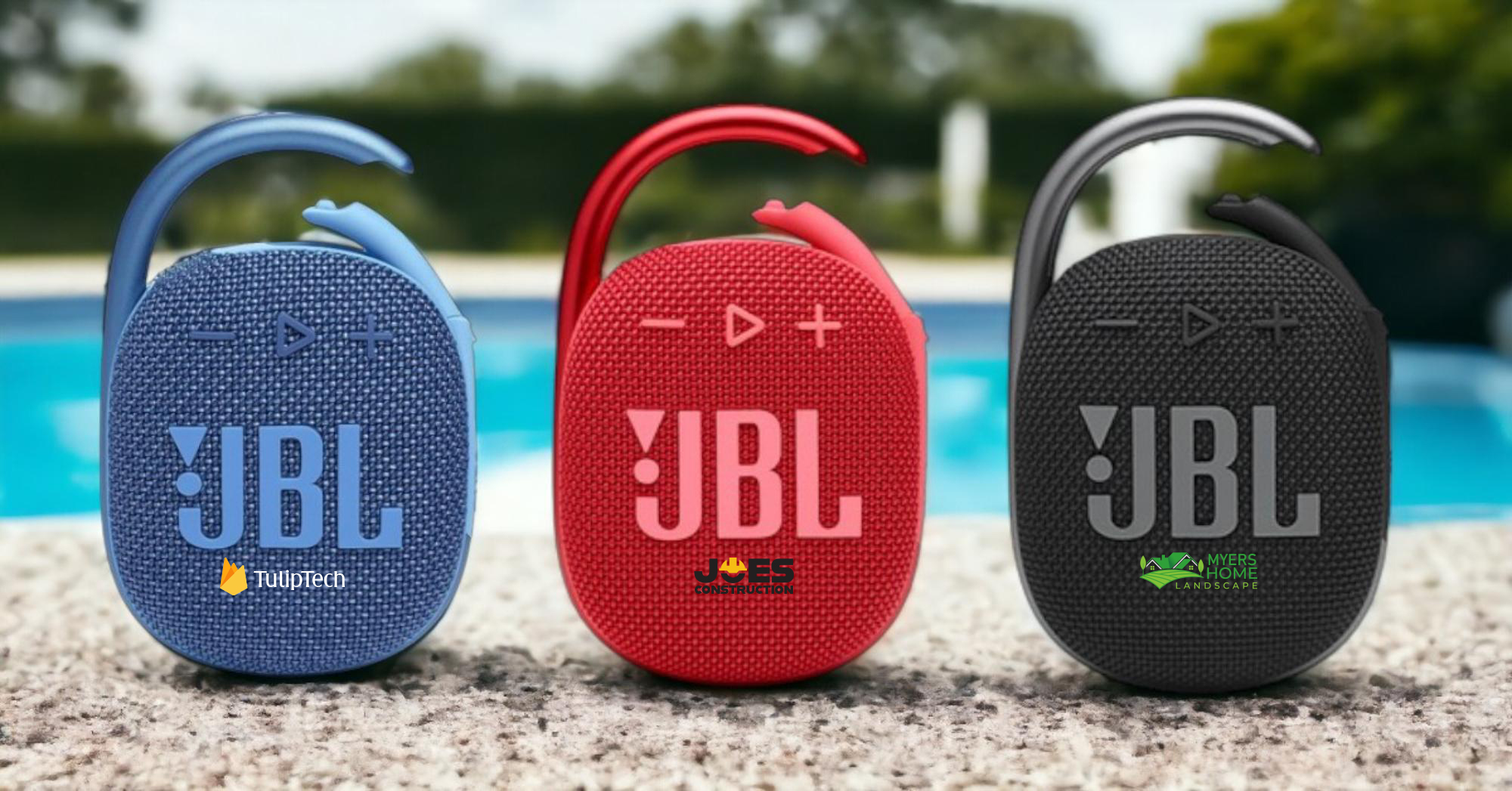 a row of three JBL wireless speakers customized with business logos