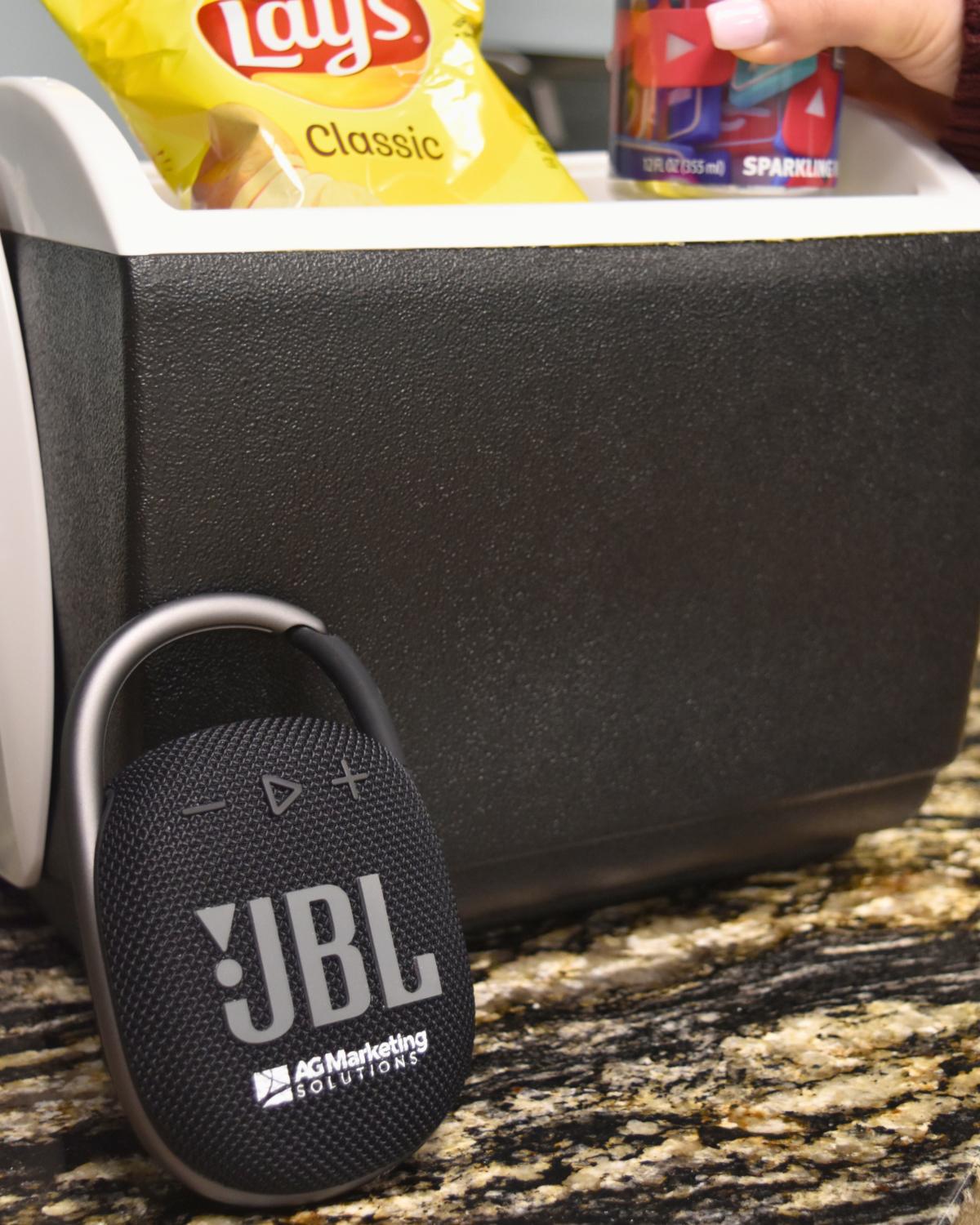 black customized JBL speaker leaning against a cooler